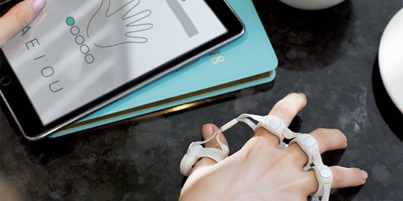 A woman wears her Tap to play games with her iPad tablet