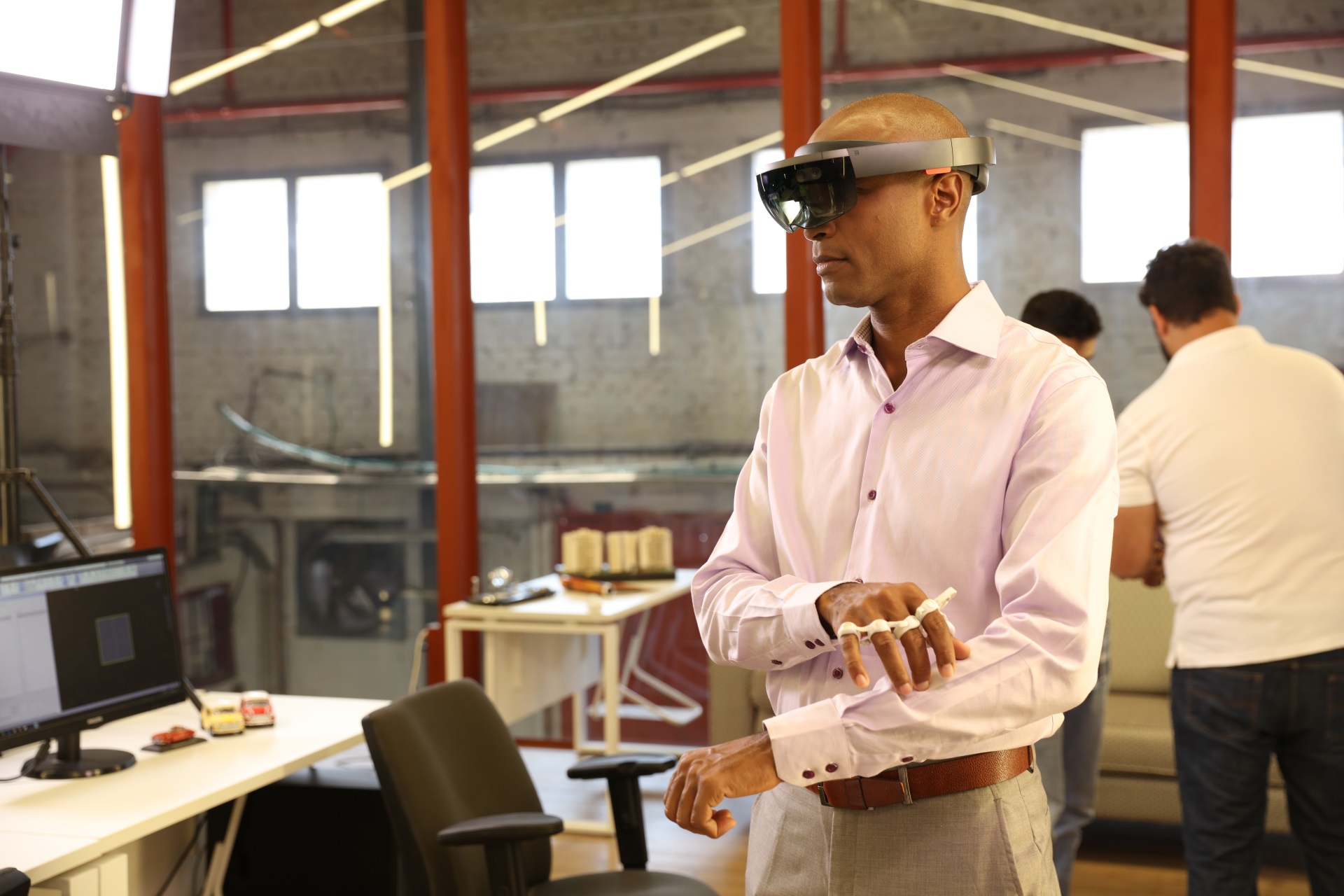 A man uses the Tap with his Hololens AR headset to navigate