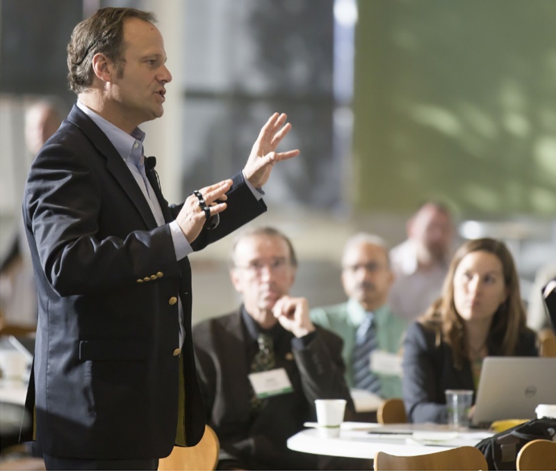 A man controls his powerpoint with Tap for a truly unique speaking presentation
